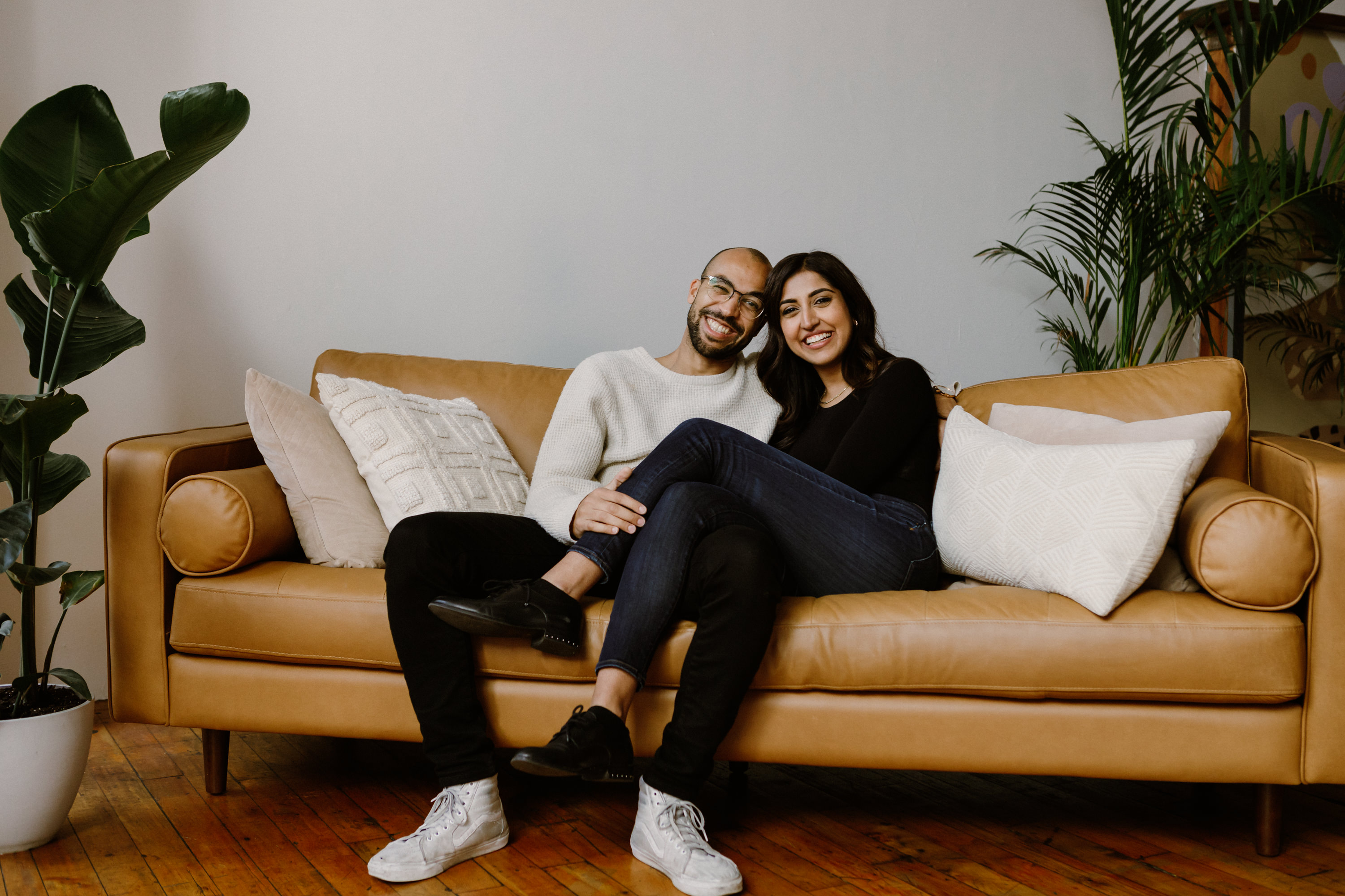 A really cute picture of Amna and Shola sitting on a couch.